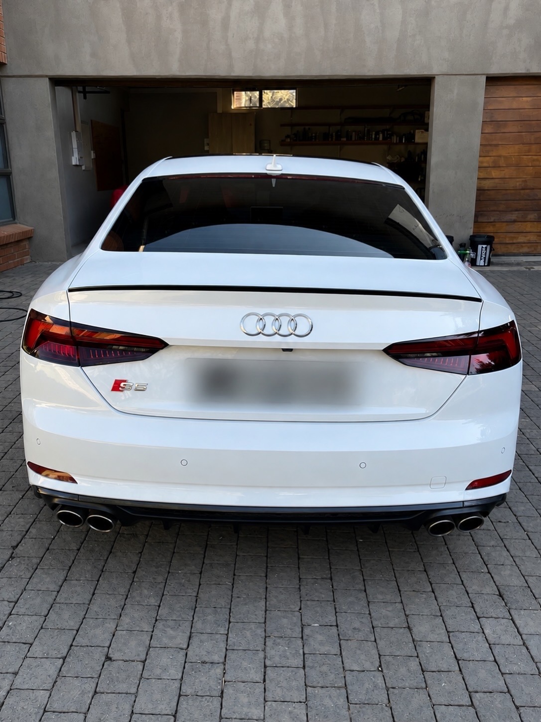Rear of a freshly detailed white Audi S5