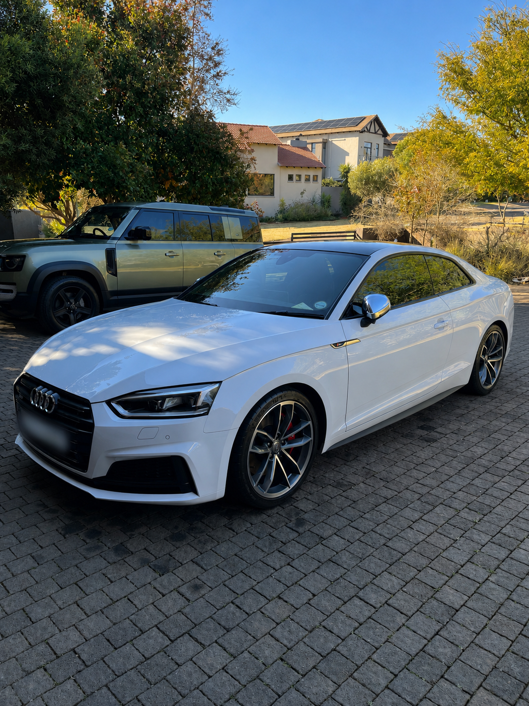 Detailed white Audi S5 Coupé front three-quarter with glossy paint
