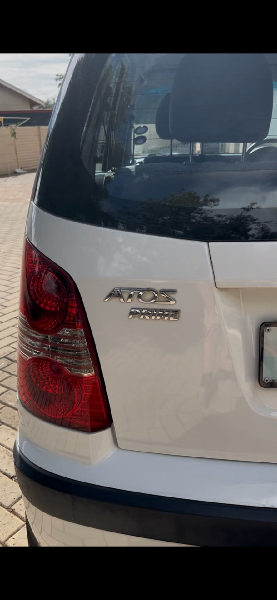 Freshly detailed white Hyundai Atos Prime exterior with glossy paint